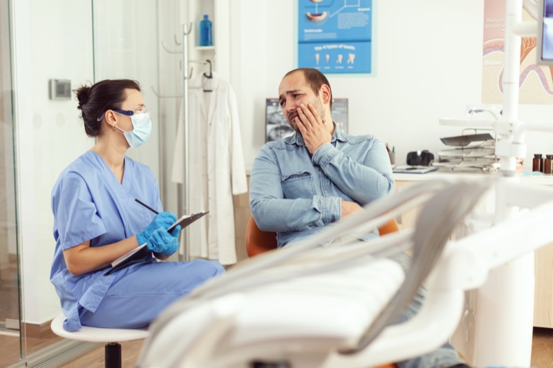 Dental assistant preparing for emergency dental treatment