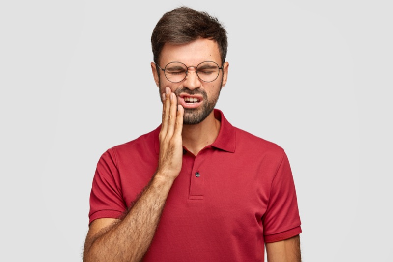 Man with toothache needing emergency dental care in Lynnwood